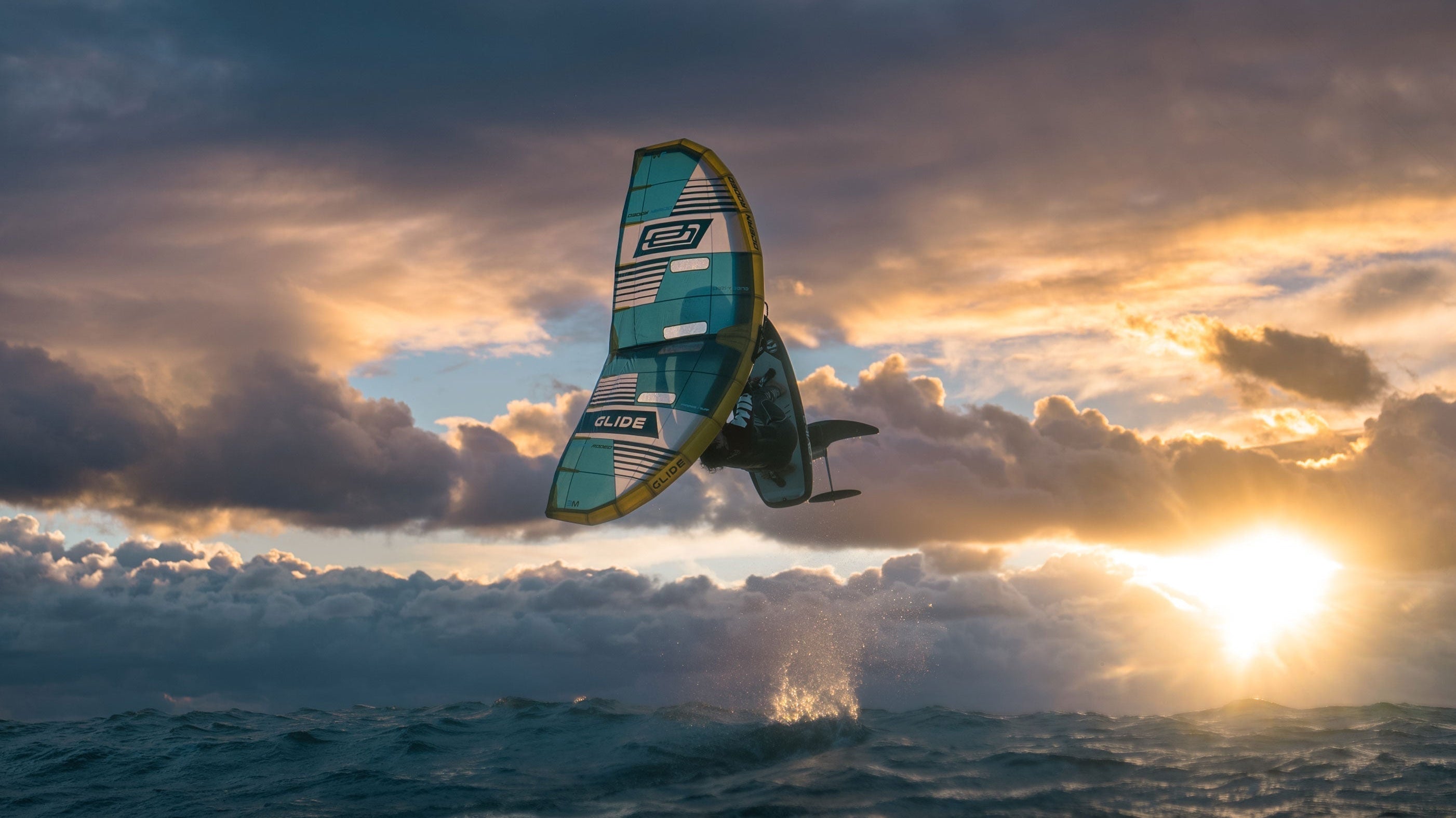 Mathis Ghio using the Ocean Rodeo Glide A-Series Wing in front of a moody sunset