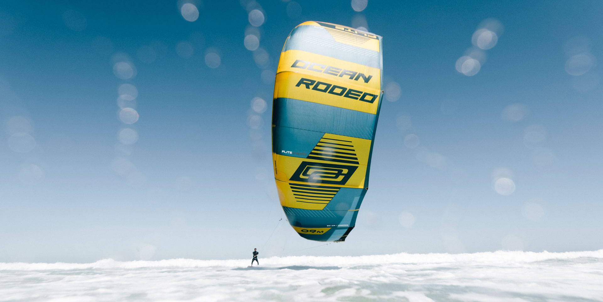 Ocean Rodeo kite above white water.